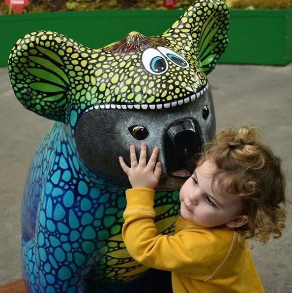 Popular festival: Koalasaurus Ma whispers to a little friend at the Royal Botanic Garden Sydney.