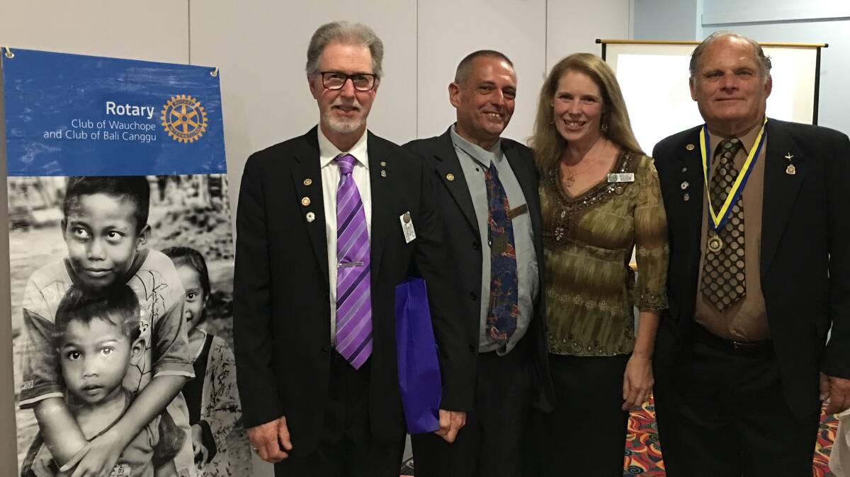 Thank you: Kevin Whitbread and Paul and Suzanne Pollett were acknowledged with the Paul Harris Fellow as outgoing president Reg Pierce looks on.