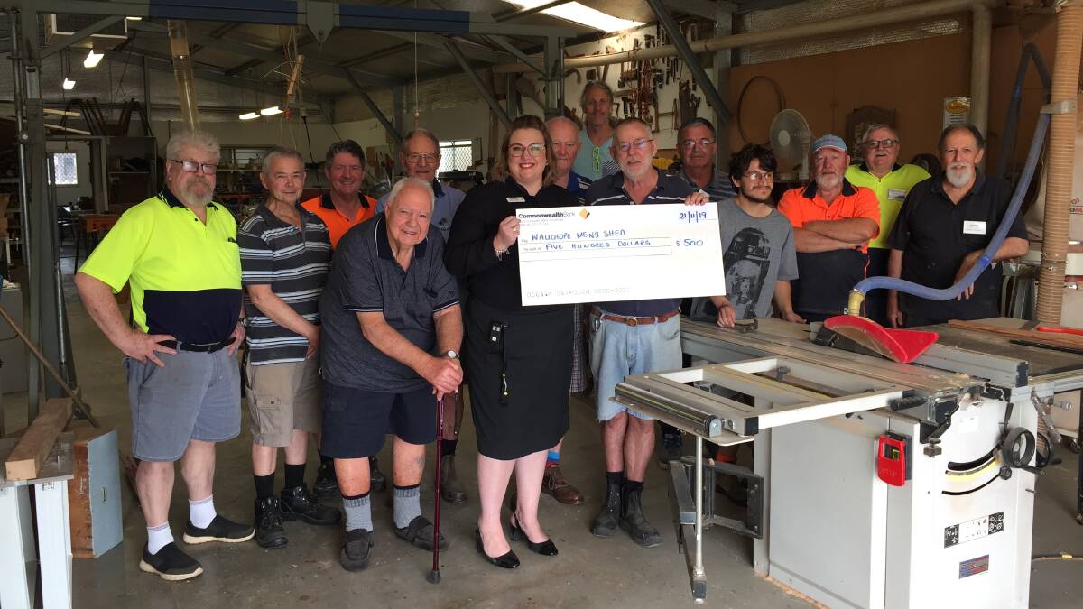 BIG HELP: Lauren Pye, CommBank branch manager hands over a large cheque to the Mens Shed at Wauchope Showground.