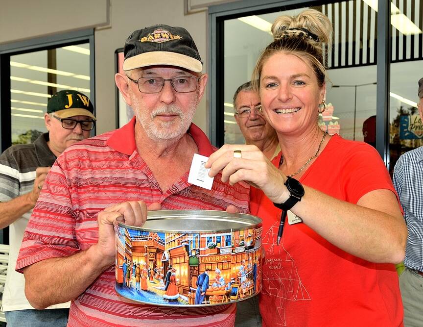 Robert Read, president of Wauchope Men's Shed with Kylie Joseph, IGA head supervisor drawing the winning raffle ticket.