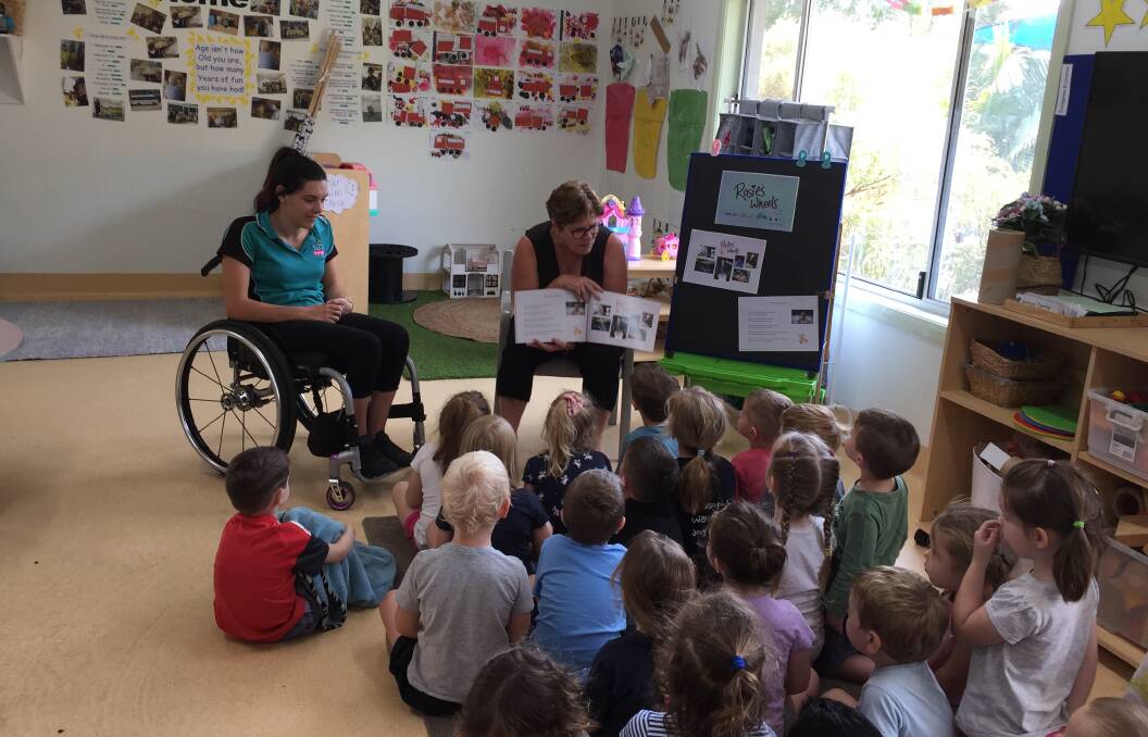 Rosie with Annette Holley who wrote the book and the kids at TG's Childcare at High Street in Wauchope.