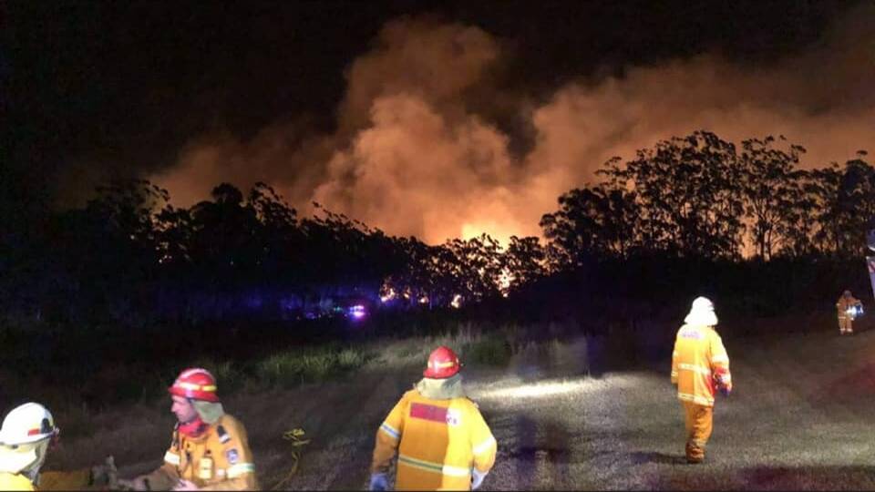 VIVID MEMORIES: Comboyne Rural Fire Brigade members fighting the bushfires there two years ago. They need more volunteers.