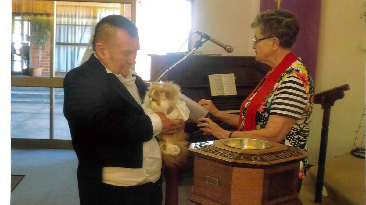 CAT BAPTISM: Scott Secombe with his pussy, Pope Francis and Bronwyn Fisher from Wauchope Uniting Church.  Photo supplied.