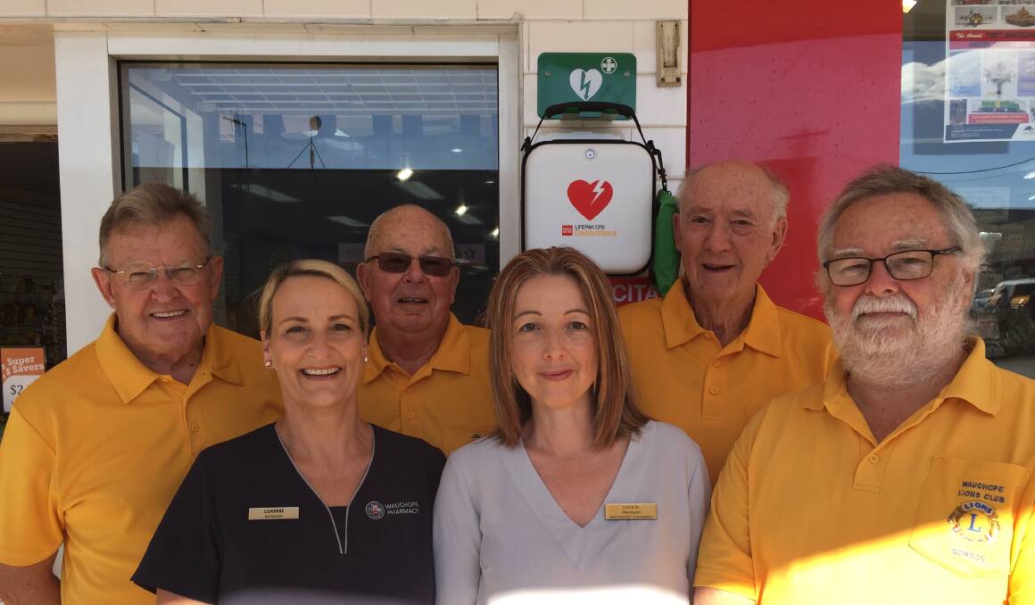 LIFESAVER: Members of the Wauchope Lions Club with staff from Wauchope Pharmacy with the new defibrillator in our town's High Street.