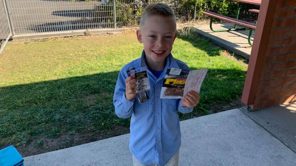 WINNER AND GRINNER: Jacob Pope, our September outing junior champ, with his lure pack and voucher.