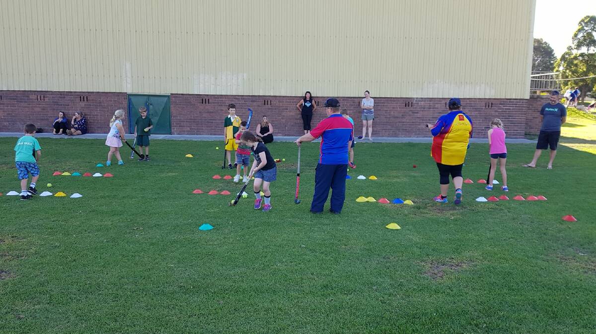 Coach Colin Pursehouse teaching the 4-7 year-olds stick stills at Wauchope Hockey Club's free Come and Try session.