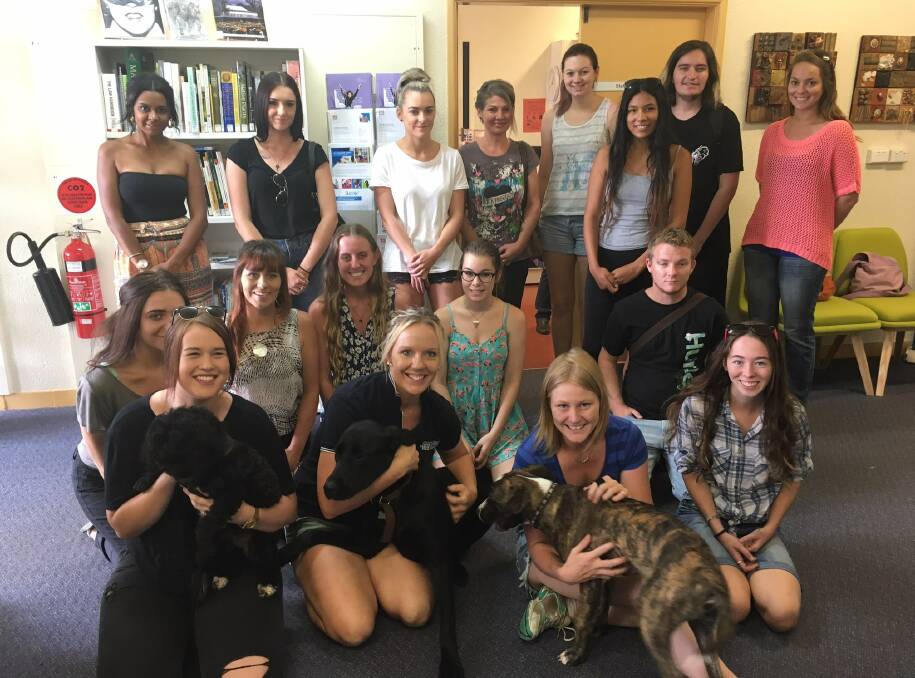 HAVING A CUDDLE: Students from the Animal Studies class at Wauchope TAFE.