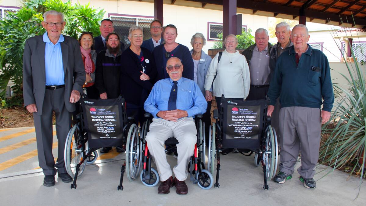 Lodge Star of Wauchope Past Master Harry Lavender, Masonicare representative Robert Drysdale (seated) and (right) Ray Posner representing Hastings Macleay Freemasons Association with three of the six wheelchairs donated to Wauchope Hospital. Pictured with them are Alicia Garth, Chris Stephens, Andrew Garth, Registered Nurse Gwyneth Trigg, Douglas Gilbert, Nursing Unit Manager Kate Williams, Hazel Lavender, Cathy Posner, Cec Scaysbrook and Glen Leonard.