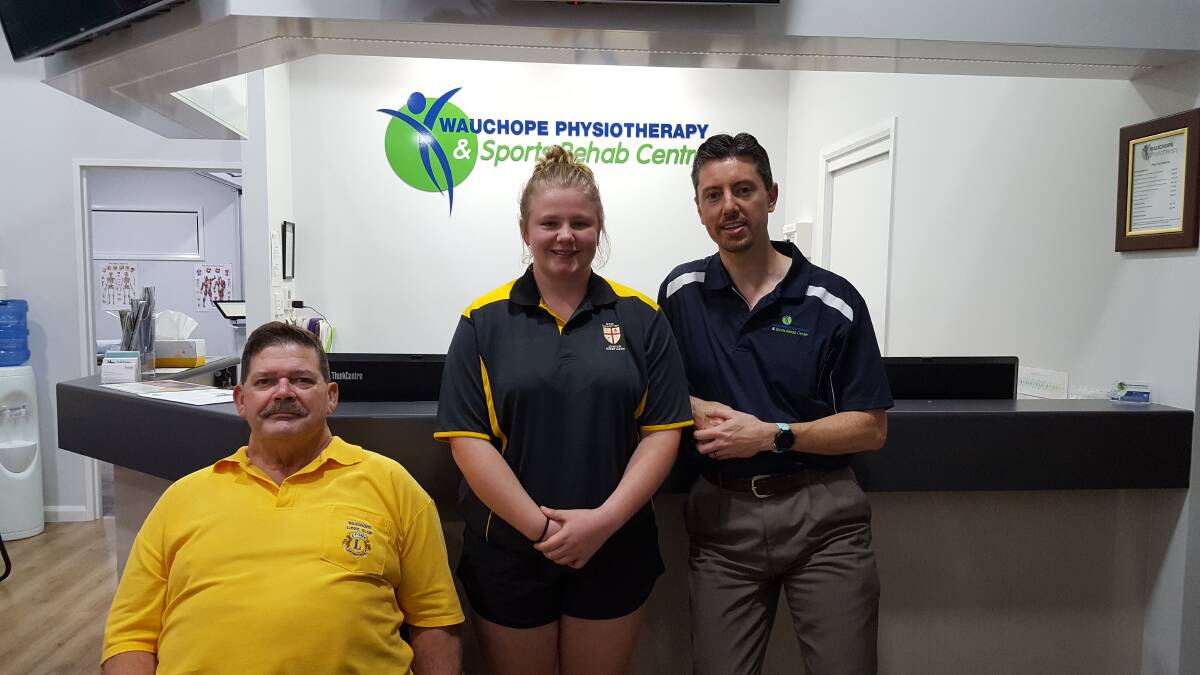 HELPING HANDS: Stephen Perkins from Lions Sports Foundation, Natalie Towle and sponsor Nathan Lynch from Wauchope Physiotherapy.