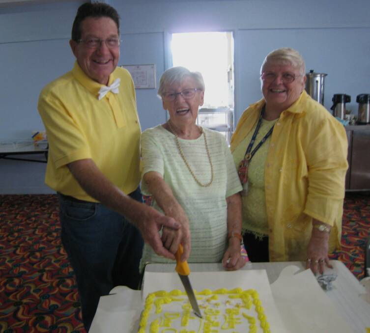 CUTTING THE CAKE: Bill Wagner, Brenda Foster, May Sale.