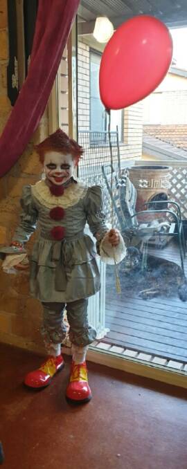Cayden clowns around in Halloween horror garb