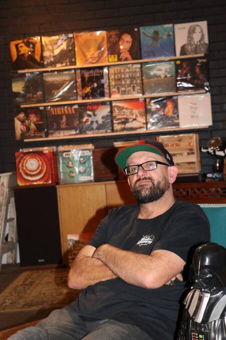 MUSIC-LOVER: Travis Fredericks takes a trip down memory lane with vinyl records at Dark Alley Collectables.