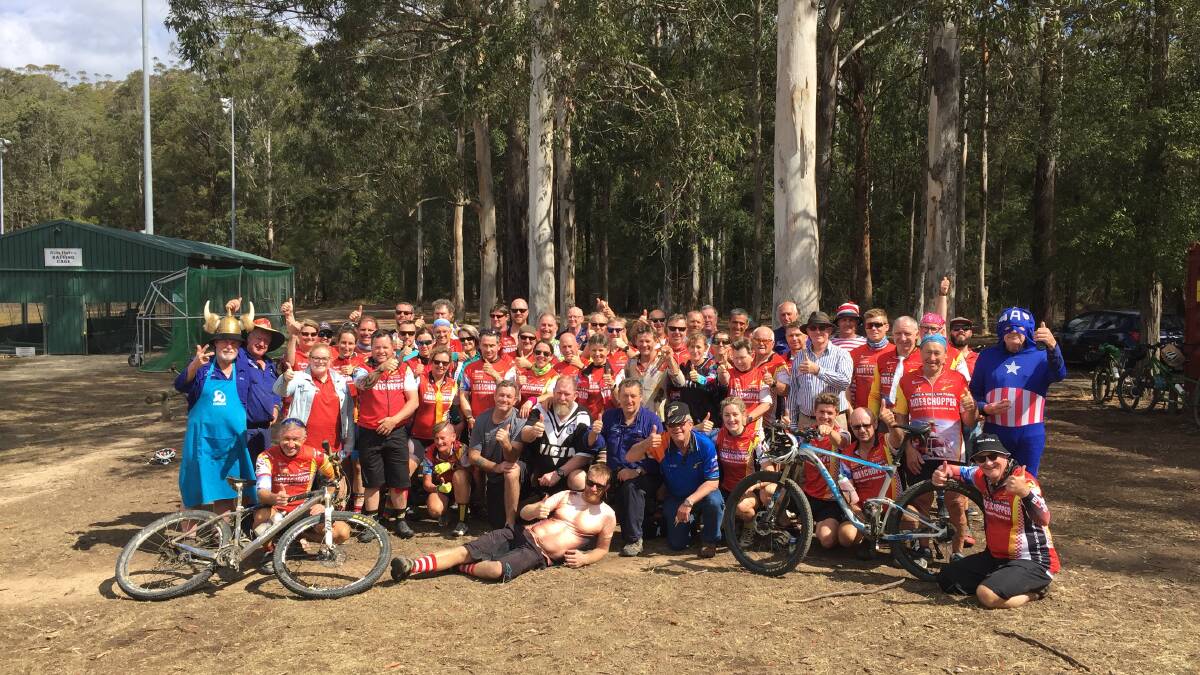 THUMBS UP FOR WAUCHOPE: The 65 cyclists and 10 crew who've raised over $60,000 for the Westpac Rescue Helicopter stop for lunch at Blackbutt Park. Photo: Letitia Fitzpatrick.