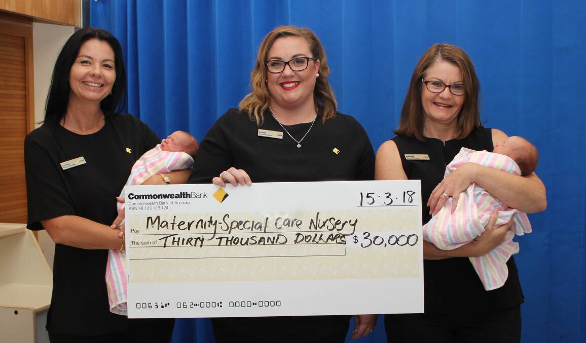 Port Macquarie Branch Manager Corrine Wickham, Wauchope Branch Manager Lauren Pye and Laurieton Branch Manager Pauline Hoad present $30,000 for specialised patient equipment to Port Macquarie Base Hospital.  Among the special guests are new-born twins Thea and Sage Wheeler.