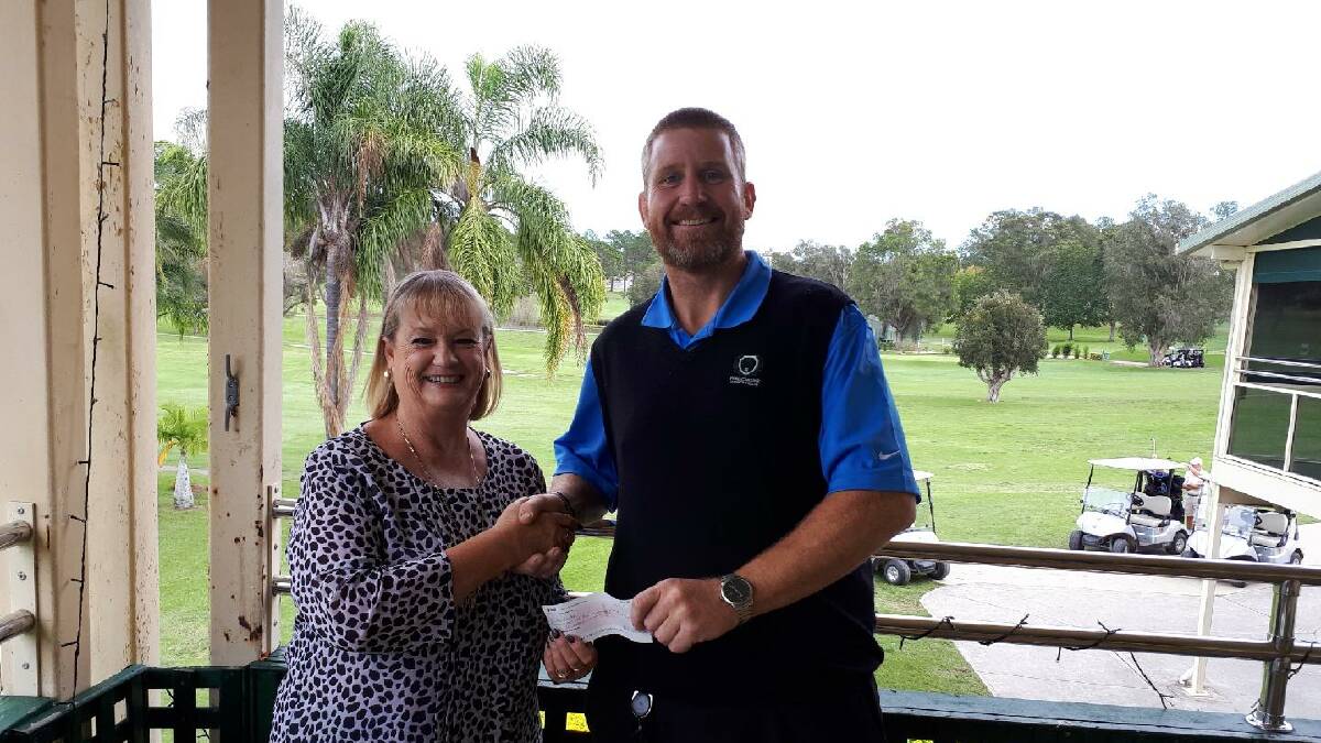 Golf event organiser Michelle McDonald is all smiles as Wauchope Country Club manager Caleb Rose hands her a cheque back for the green fees.