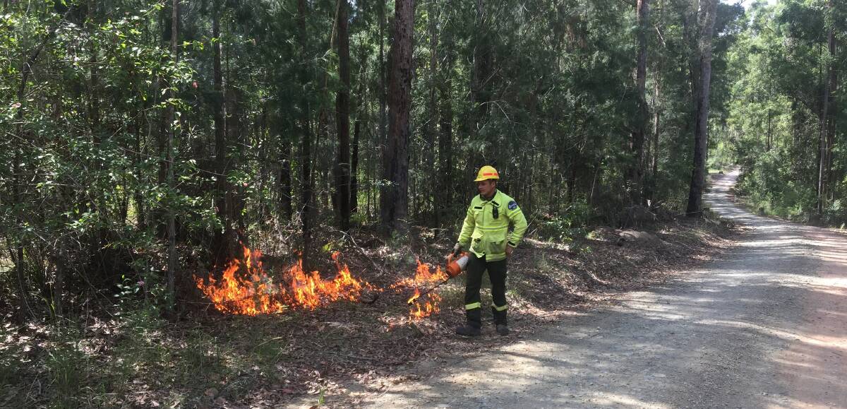 Forest technician Matt Model with a burner for carrying out hazard reduction burning in local state forests.