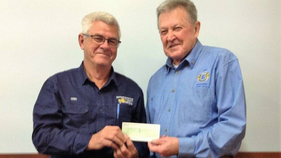 HELPING HAND: Greg Cavanagh, secretary of Wauchope Yesteryear Truck and Machinery Club with Wauchope Lions Club president, Mike Hussey, holding the cheque for $7,500.