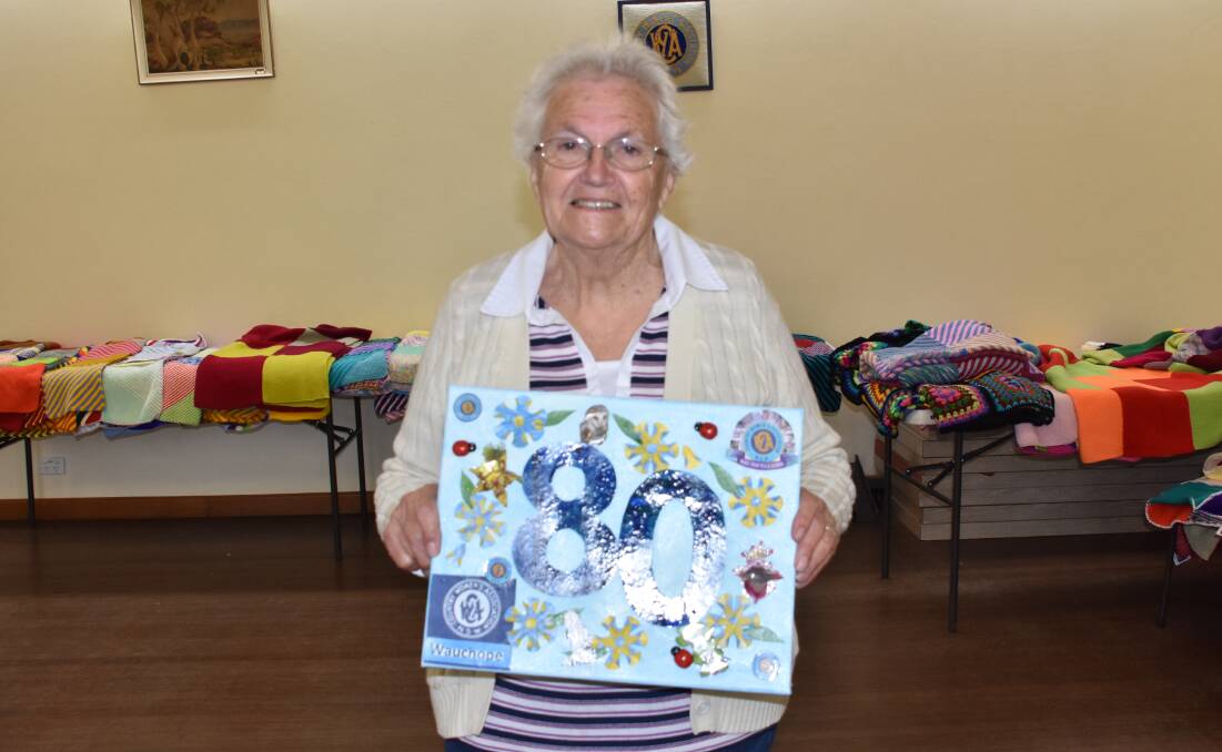 CWA patron Barbara Murphy with a special memento of their big anniversary.