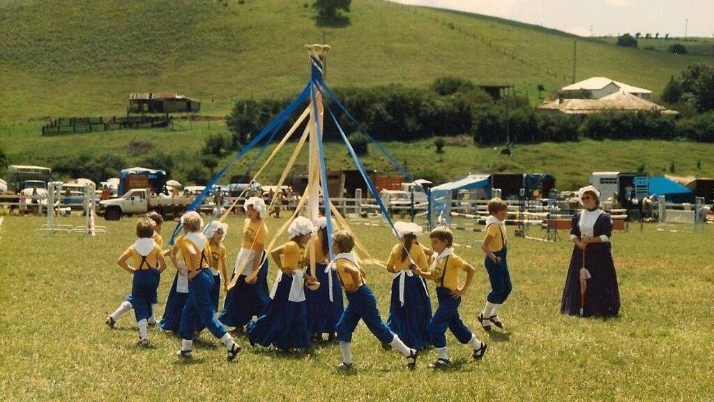 MEMORIES: Comboyne teacher Heather Coombes looks on in pride as the children in 1988 perform the Maypole Dance to commemorate similar performances throughout the history of the Plateau.