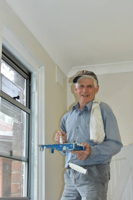 HELPING HAND: Volunteer Geoff Bond is happy to paint the upgraded kitchen.