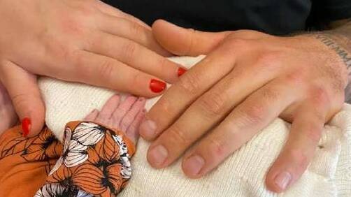 Jenna Lantouris and Charley Alderman hold their baby Kora in hospital.