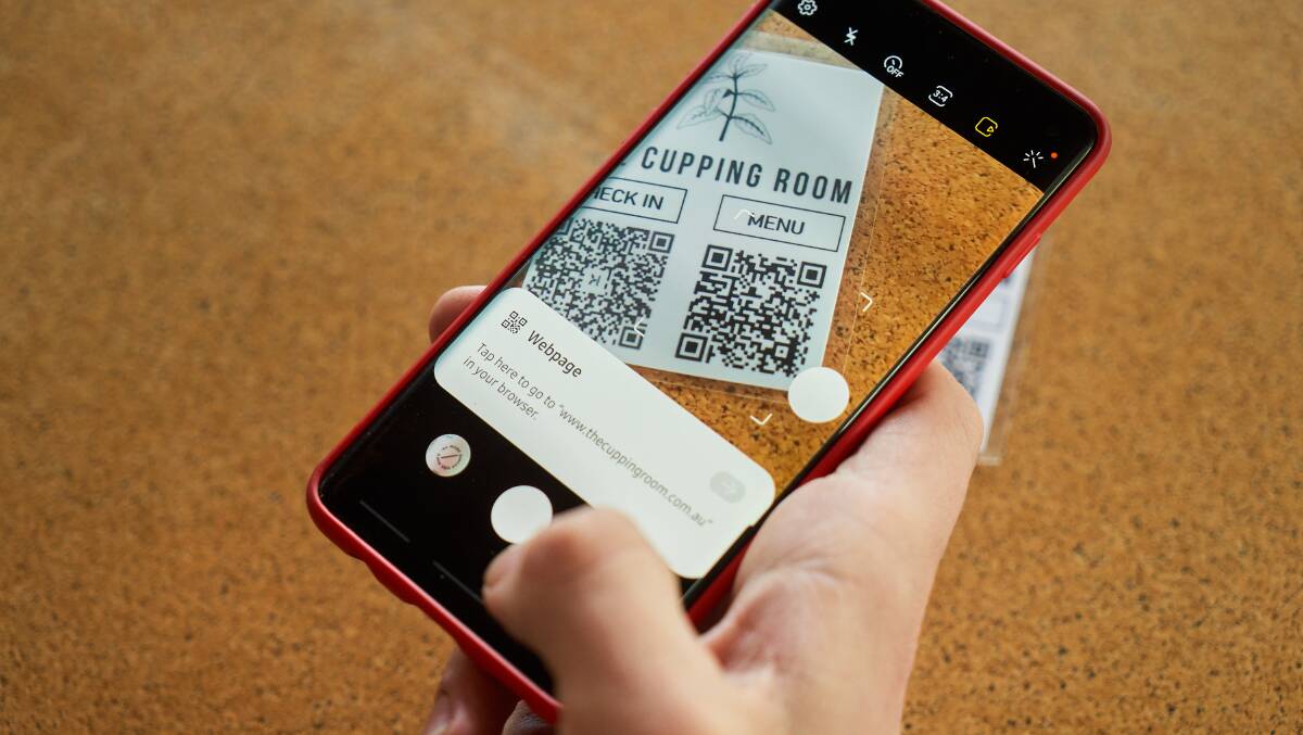 The Cupping Room's manager, Connor Crampton Smith, using QR codes to check-in and view the menu. Picture: Matt Loxton
