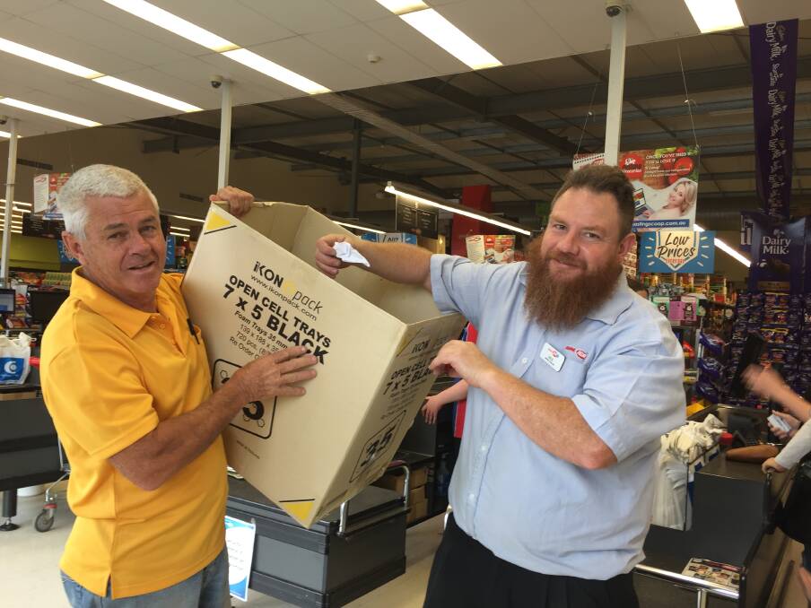 GOOD CAUSE: Lion Greg Cavanagh and IGA Grocery Manager, Michael Smith, drawing the winning ticket.