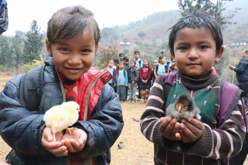 CHICKENS: Some of the children with the chickens that will mean they will get an education.