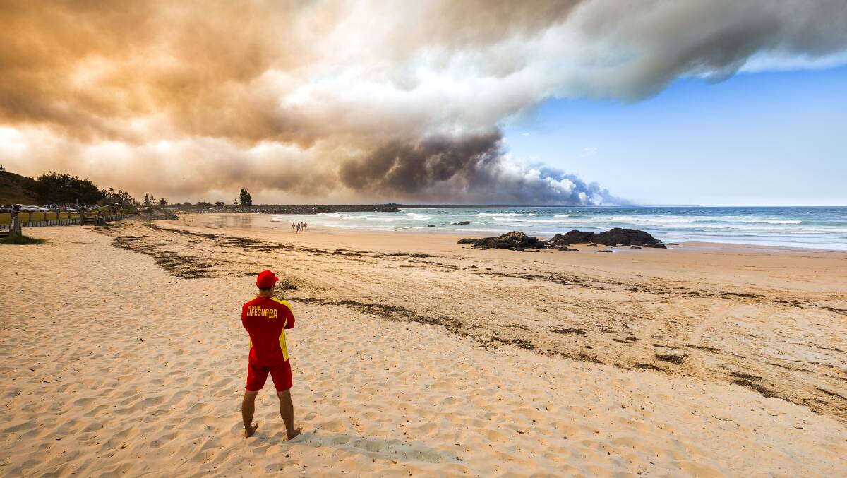 Lifeguard Brae Pettiford watches the drama from Town Beach. Photo: Ivan Sajko