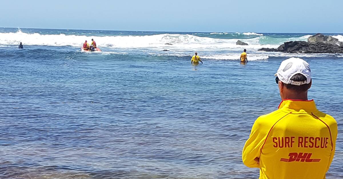 Search in the waves: Volunteers check the water in close to the shore of Shelly Beach.
