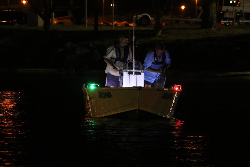 Fish ahoy: Two men fishing at night. Photo: Supplied/Roads and Maritime Services.