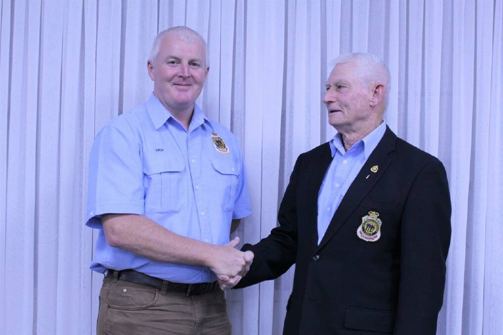 New strategy: Incoming president of the Wauchope RSL Sub-Branch, Mick Brownlow (left) being congratulated by the outgoing president, Des Hancock. Photo: Wauchope RSL Sub-Branch.
