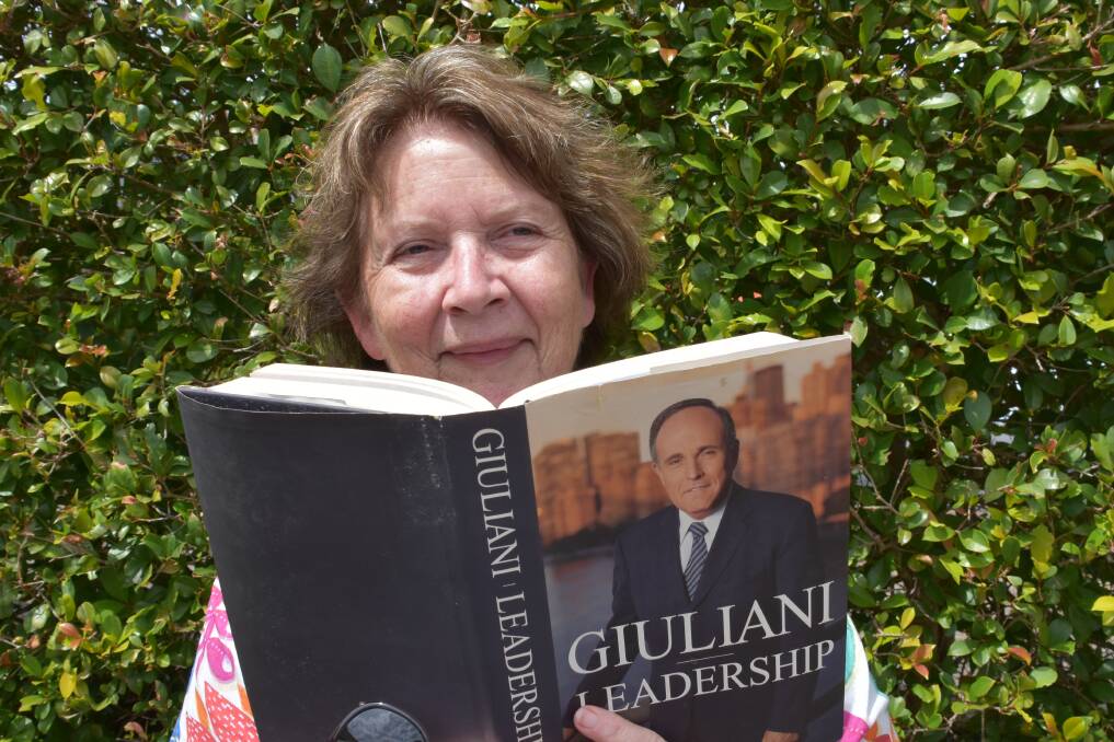 COMMUNITY GENEROSITY: Rotary Club of Wauchope president Diana Reynolds with a book from the book sale.
