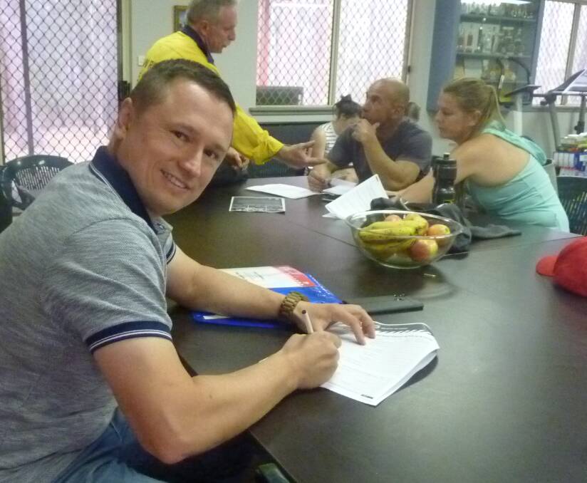 Keen to help: Vladimir Kolganov fills out the recruitment paperwork as a step towards becoming a volunteer firefighter.