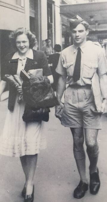 Betty and John walk down Sydney's Castlereagh Street on the day before they got married.