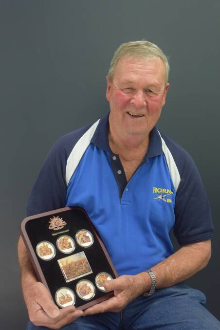 Author Greg Raffin pictured with a set of medallions commemorating the Battle of Lone Pine.