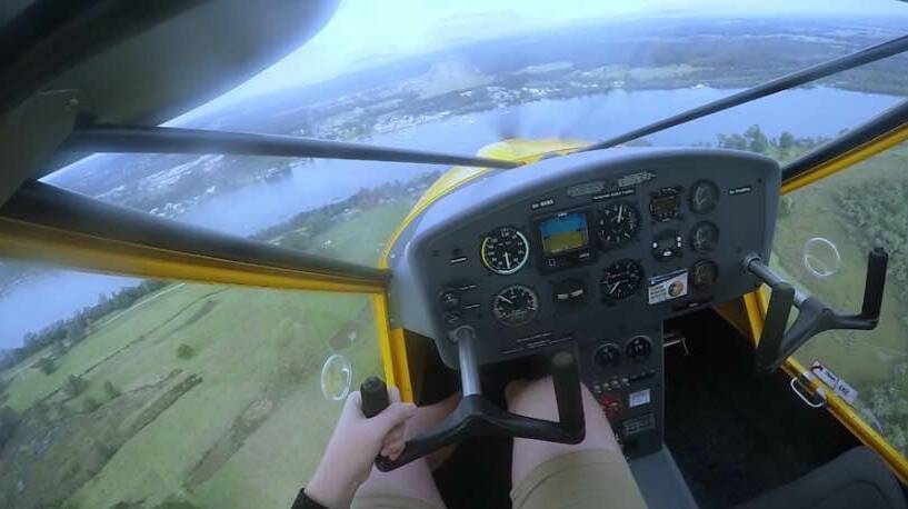 Great view: Alex McGee at the controls of a light sport aircraft.
