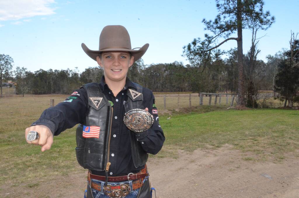 World stage: Levi Ward proudly shows off his new ring and buckle after a second place finish at the Youth Bull Riding World Finals. Photo: Callum McGregor