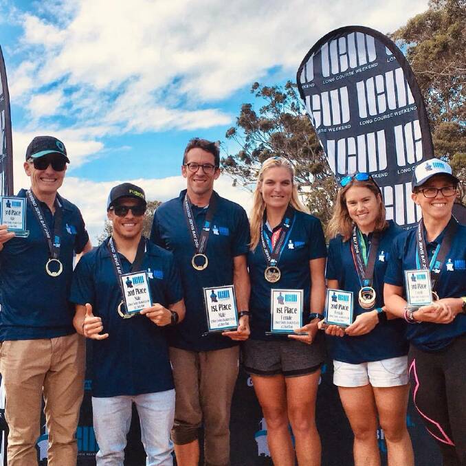 Big win: Mel Cockshutt (centre) with her winners medal and plaque. Photo: LCW Jervis Bay Facebook